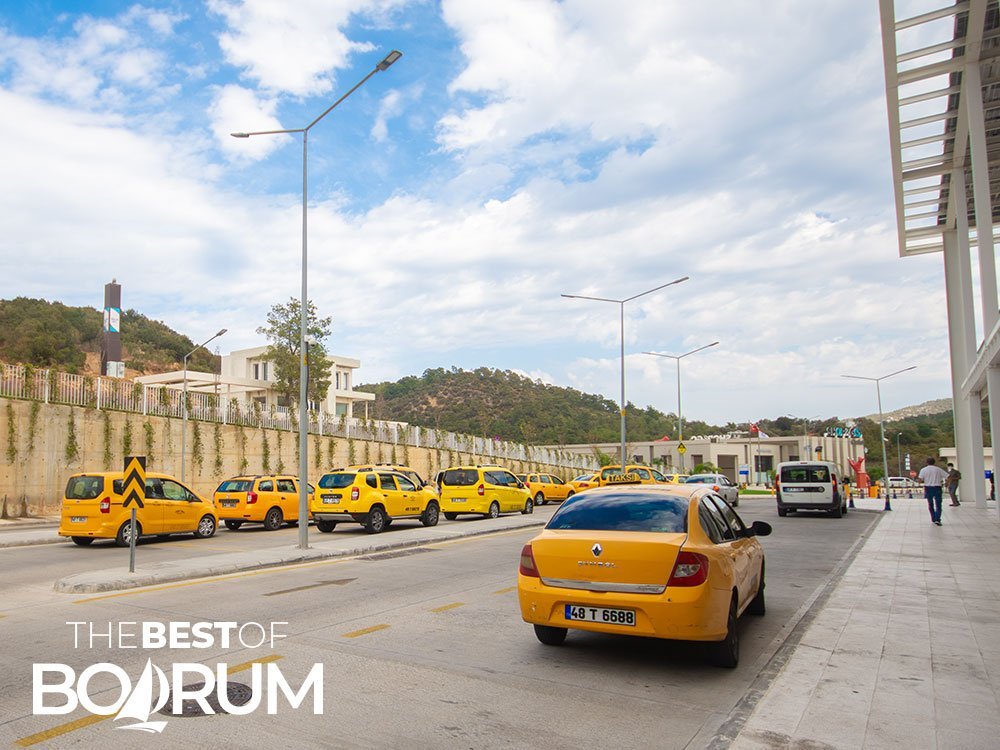 Yellow taxis lined up and waiting for customers at the Bodrum intercity bus terminal.