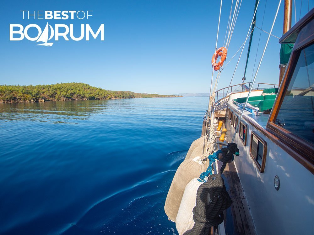 A wooden gulet sailing through the Gulf of Gökova, one of the highlights featured in Turkey Travel Guides.