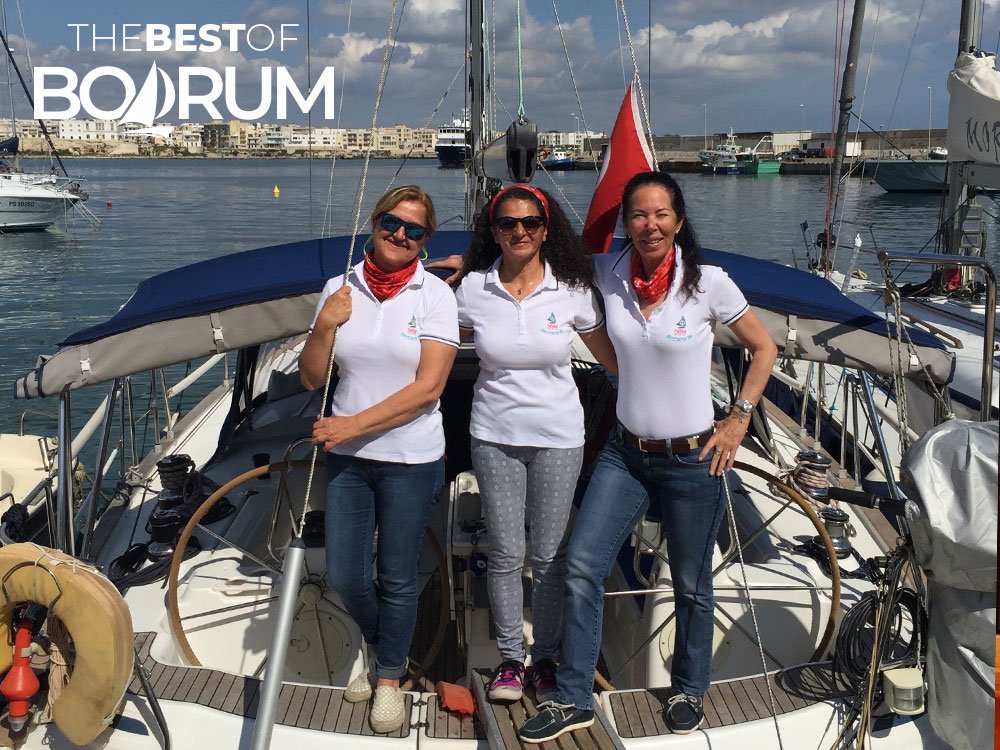 Pırıl Adanalı and her fellow sailors from the Yüksek Ökçeler crew posing proudly on a sailing boat.
